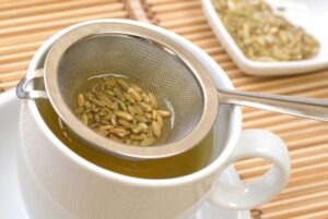 fennel-seeds-in-a-tea-strainer-over-a-mug-of-herbal-tea