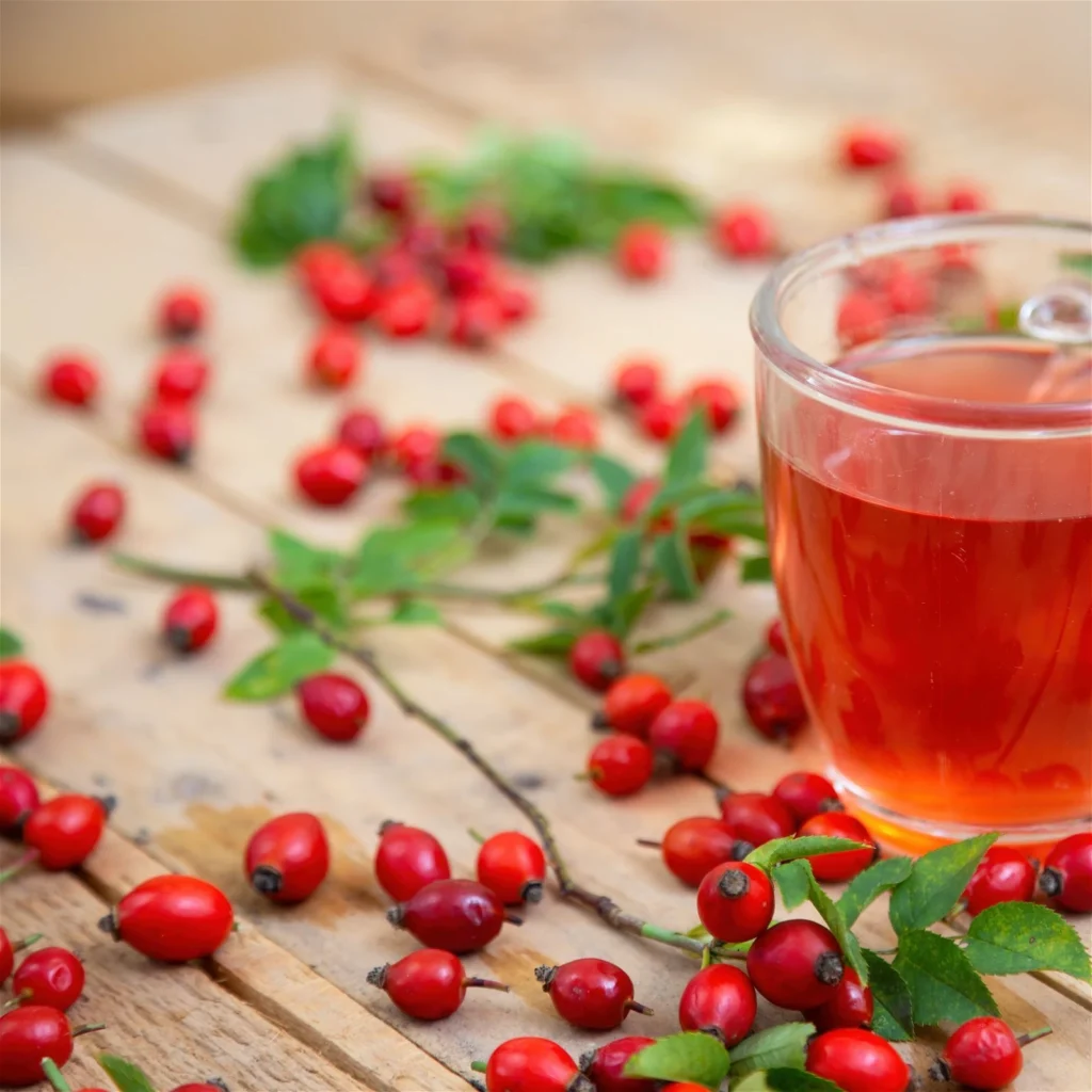 glass-of-rosehip-tea-on-brown-palette-with-leaves