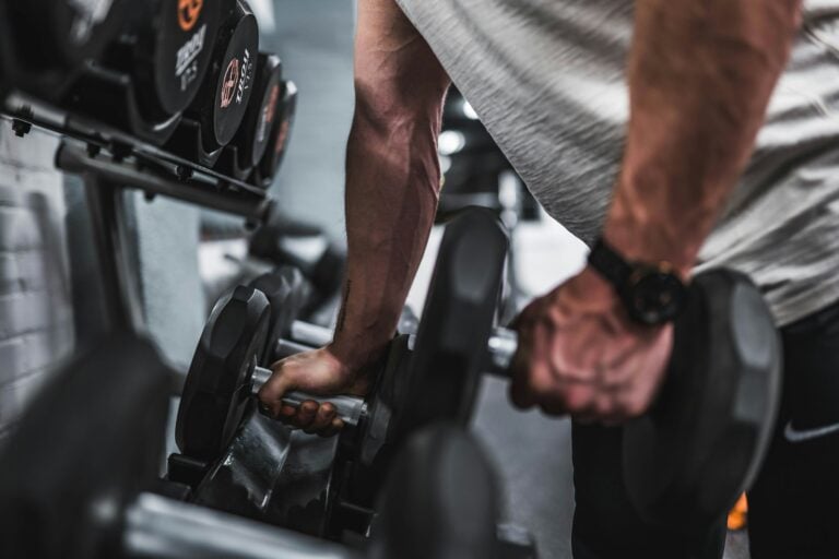 Athlete using shoulder press machine for deltoid training